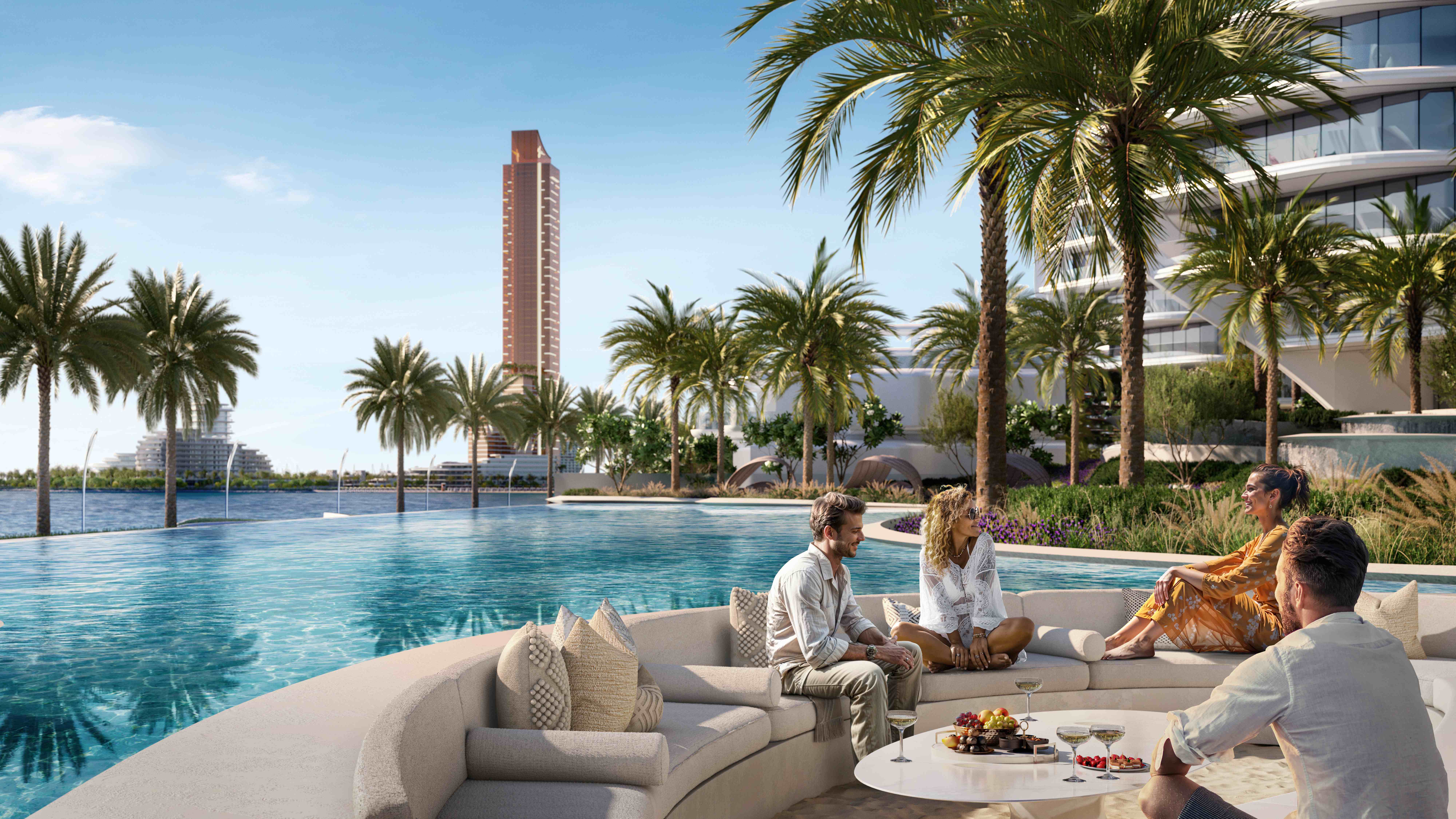 Exclusive poolside lounge area with curved beige sofas, infinity pool, palm trees, and Wynn tower backdrop at Al Marjan Island beach club