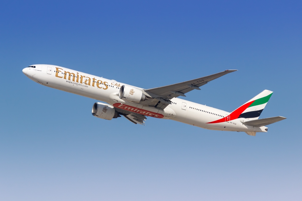 Emirates airline aircraft representing global connectivity from Al Marjan Island Ras Al Khaimah to 70% of world population within 8 hours flight time
